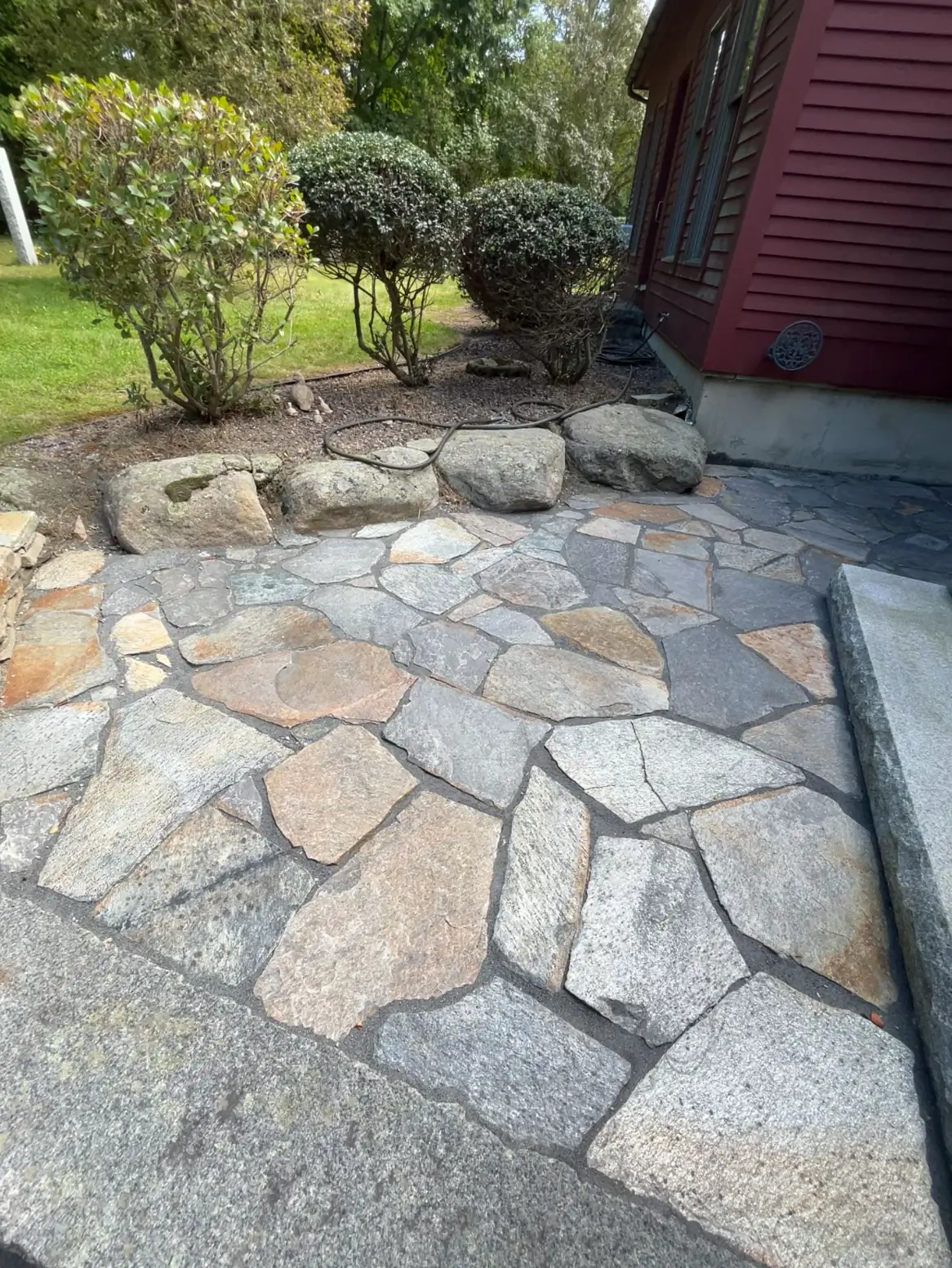 Natural stone patio beside the house